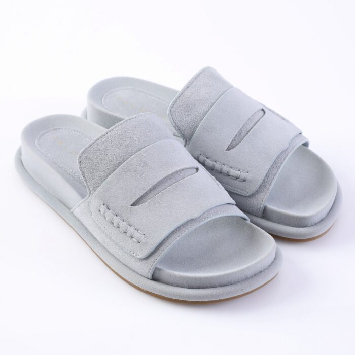 Light gray suede slide sandals with two wide straps and open toes on a white background, casual footwear