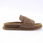 Brown suede slide sandal with a wide padded strap and rubber sole, side view.