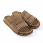 Brown suede slide sandals with two wide straps and stitched detailing on a white background.