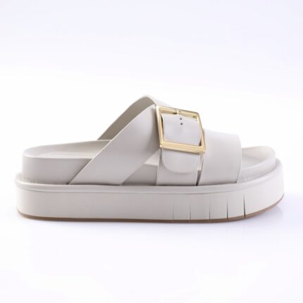 White platform slide sandal with a wide strap and gold square buckle on a chunky sole.