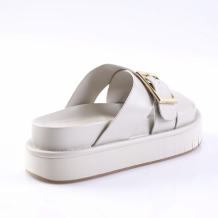 White platform sandal with two straps and a gold square buckle on the side the strap.