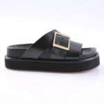 Black platform slide sandal with a wide strap and gold square buckle against a white background for a product listing.
