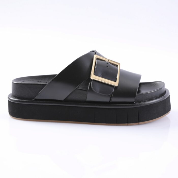 Black platform slide sandal with a wide strap and gold square buckle against a white background for a product listing.