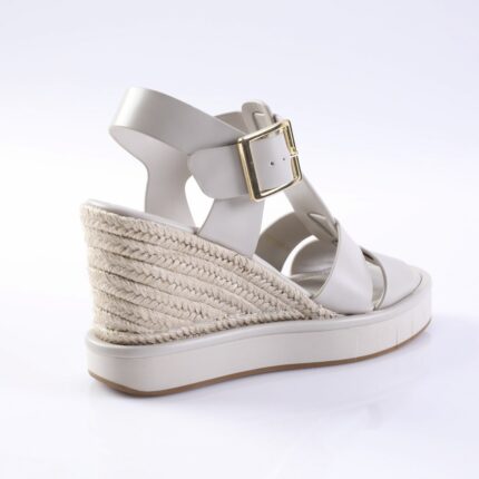 White wedge espadrille sandal with braided rope heel and gold buckle strap.