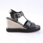 Black leather wedge sandal with a gold buckle, featuring braided jute-wrapped heel and black platform sole.