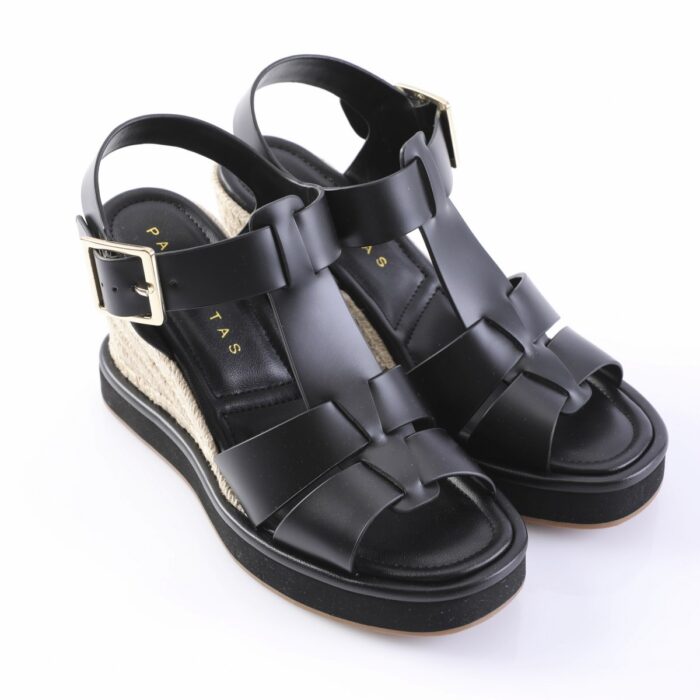 Black platform wedge sandals with braided jute heel and wide leather straps, gold buckle ankle strap.