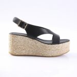Black leather wedge sandal with braided rope platform and ankle strap, side view