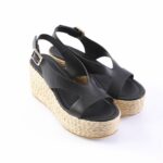 Black wedge sandals with braided espadrille platform and gold buckle.