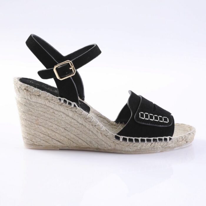Black wedge espadrille sandal with ankle strap and gold buckle on a woven jute sole