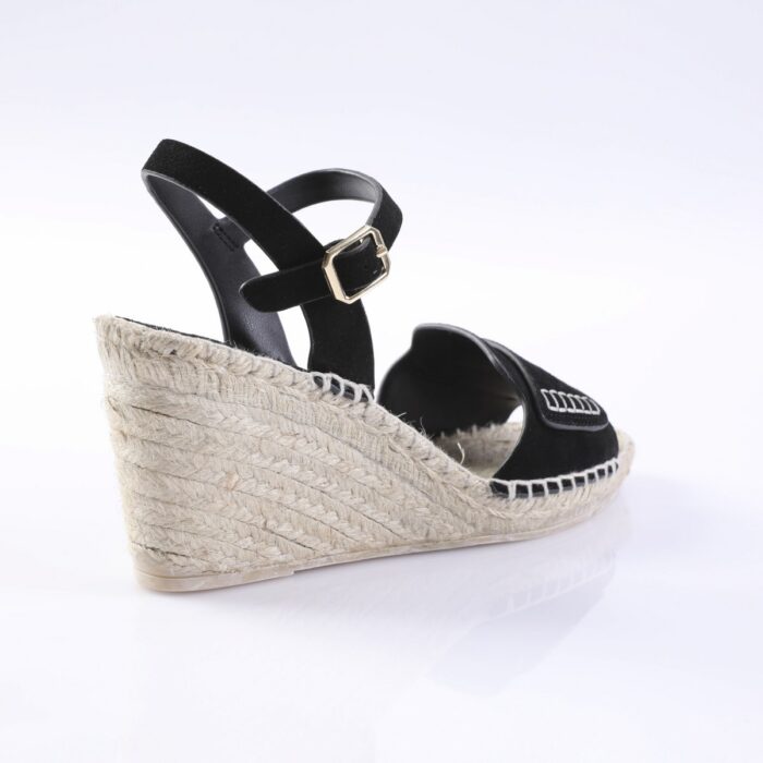 Black wedge espadrille sandal with an ankle strap and gold buckle, rope-wrapped sole visible from the side.