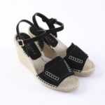 Black wedge espadrille sandals with ankle straps and front suede straps, jute-wrapped sole.