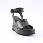 Black leather platform sandal with ankle strap and buckle, open toe, white background