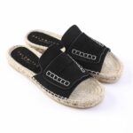 Black suede espadrille slides with a braided rope sole and white stitching detail on the straps.