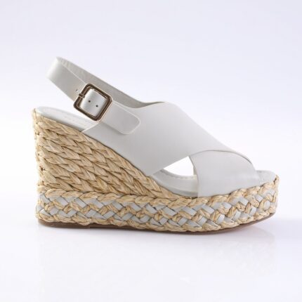 White wedge espadrille sandal with braided jute sole and white leather straps, buckle ankle strap, side view