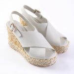 White wedge-heel espadrille sandals with a braided jute sole and white straps, open toe, and ankle buckle (fashion footwear)