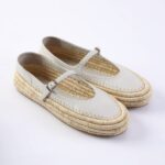 White leather Mary Jane espadrille shoes with a braided jute sole and buckle strap.