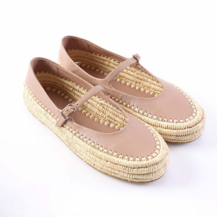 Pair of pink Mary Jane espadrille flats with woven rope soles and buckle straps on a white background