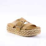 Tan leather slide sandal with wide straps and a braided jute platform outsole, featuring a silver buckle