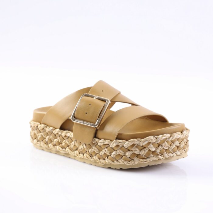 Tan leather slide sandal with wide straps and a braided jute platform outsole, featuring a silver buckle