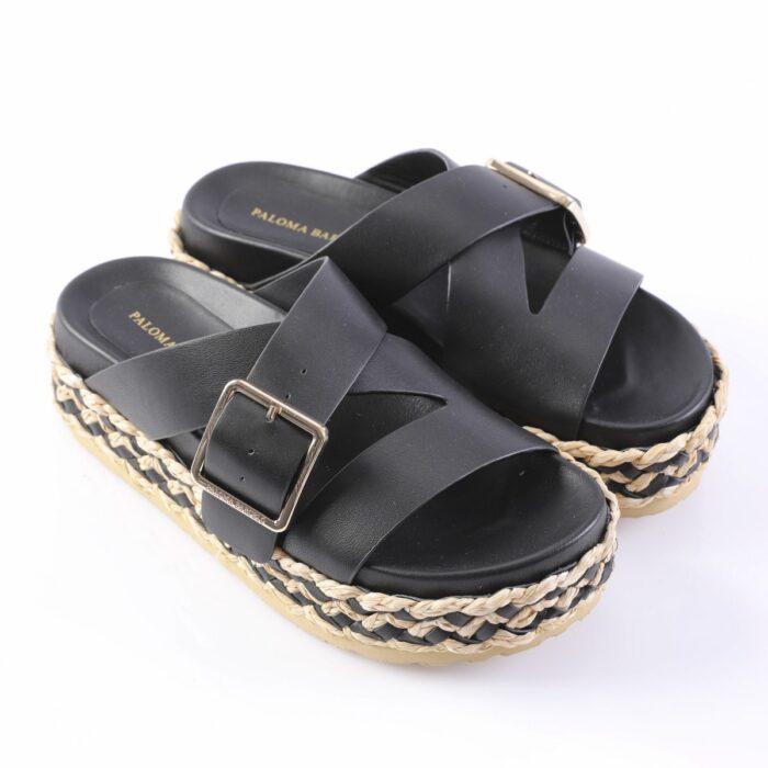 Black platform sandals with crisscross straps and gold-tone buckles, featuring a braided jute-sole edge.