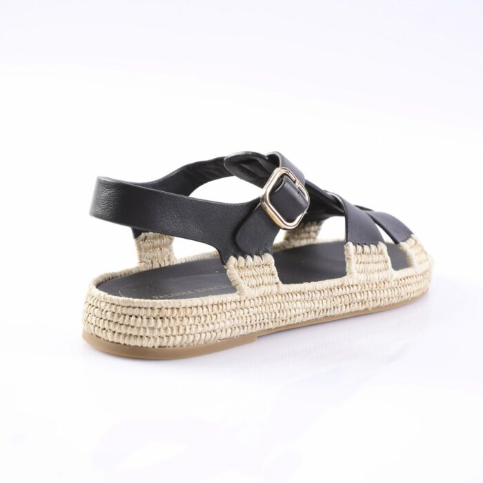 Black leather-strap sandal with a woven espadrille-style sole and gold buckle.