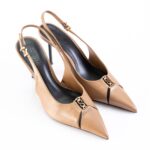 Tan slingback high-heeled shoes with pointed toes and gold buckle detail, viewed from above.
