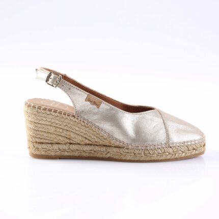 Silver metallic espadrille wedge sandal with ankle strap and braided jute sole.