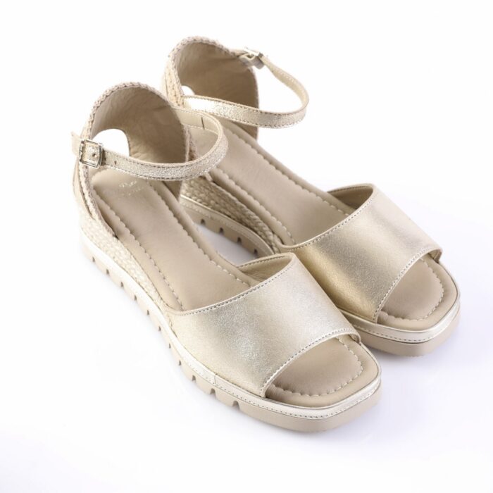 Metallic gold open-toe platform sandals with ankle strap and buckle, light-colored sole, women's summer footwear.