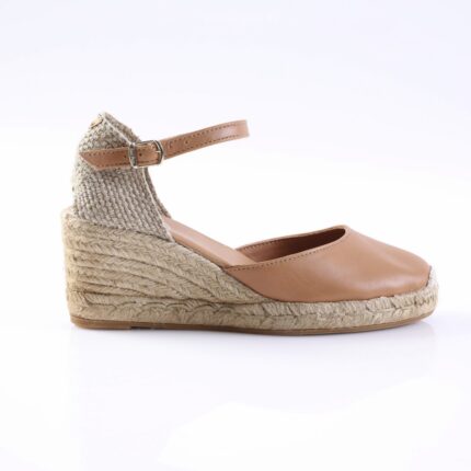 Tan leather espadrille wedge with woven jute heel and ankle strap, side view.