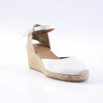 White espadrille wedge sandal with ankle strap and braided jute sole,” also showing open toe.