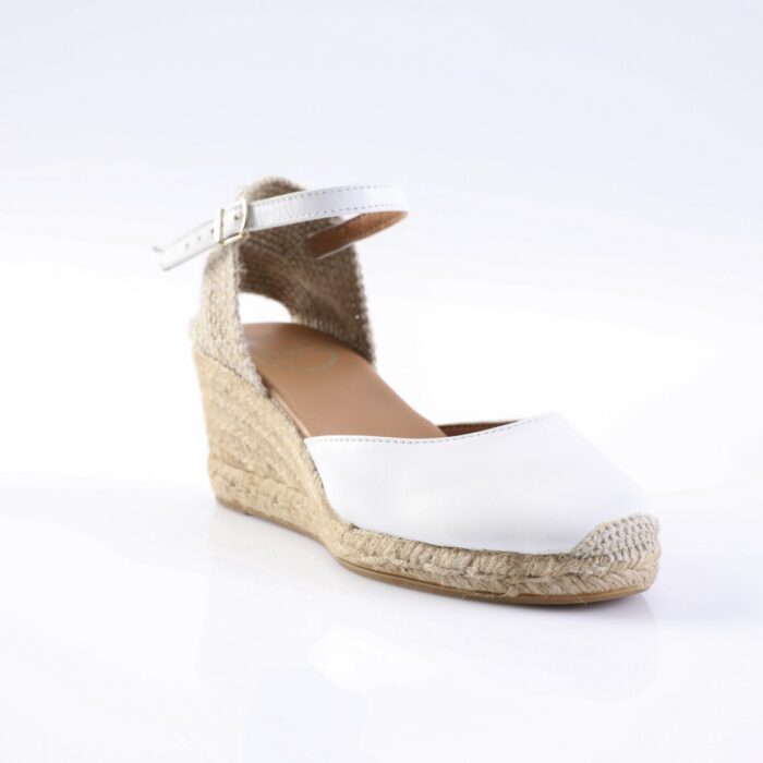 White espadrille wedge sandal with ankle strap and braided jute sole,” also showing open toe.