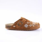 Brown suede embroidered clog-style sandal with a single buckle strap and cork footbed on a white background.