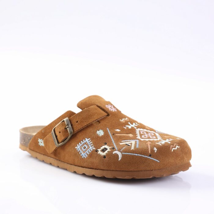 Brown suede clog/slipper with an adjustable strap and decorative blue and white embroidery on the toe area.