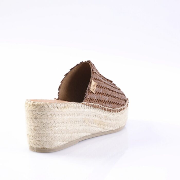 Brown woven espadrille slide with a braided jute platform heel, viewed from the back-right side, showing textured upper and rope sole.