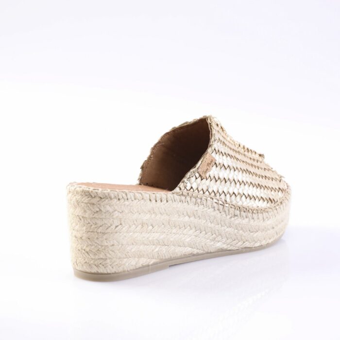 Gold braided espadrille wedge sandal with a woven jute sole, viewed from the back/side showing the open heel.