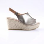 Silver metallic wedge espadrille sandal with braided jute sole and ankle strap.