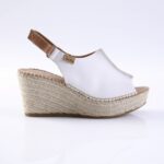 White leather wedge sandal with a jute espadrille platform and ankle strap.