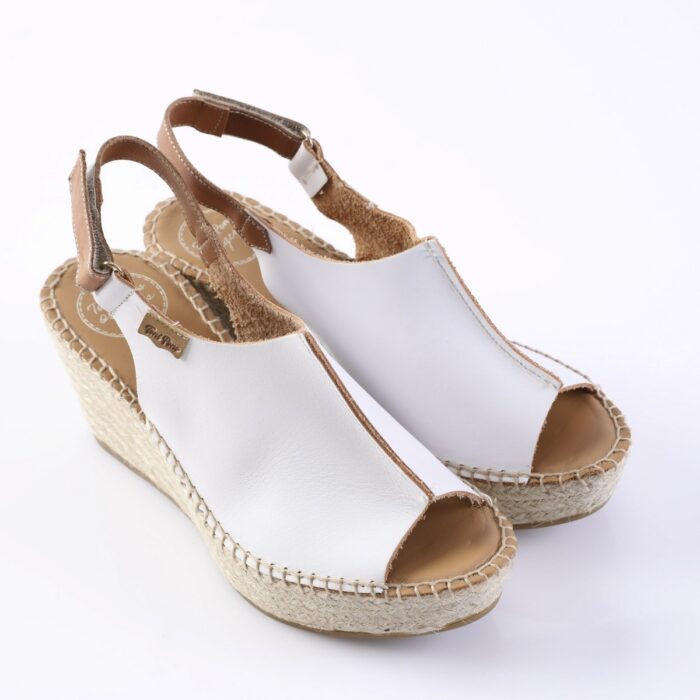 White open-toe wedge espadrille sandals with a braided jute sole and ankle strap on a white background.