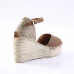 Brown leather espadrille wedge sandal with a braided jute sole and ankle strap.