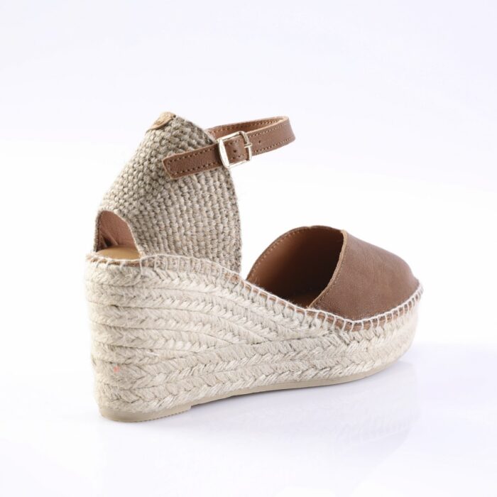 Brown leather espadrille wedge sandal with a braided jute sole and ankle strap.