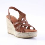 Brown leather wedge sandal with crisscross straps and a braided jute platform heel, open-toe design.