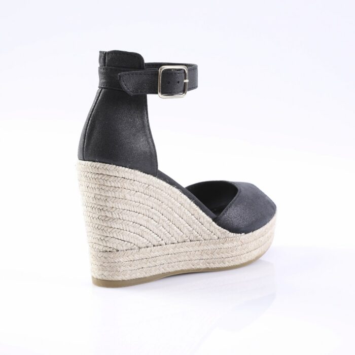 Black wedge espadrille sandal with an ankle strap and silver buckle; braided jute-covered platform and black upper.