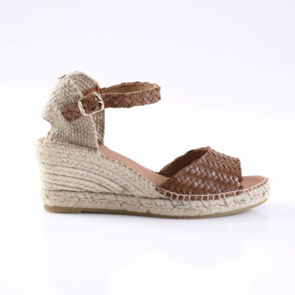 Brown woven leather wedge sandal with an ankle buckle and braided jute sole, shown in profile.