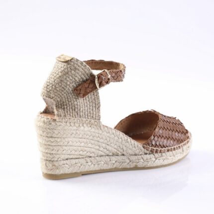 Espadrille wedge sandal with a natural rope sole and brown woven leather upper, ankle strap with buckle