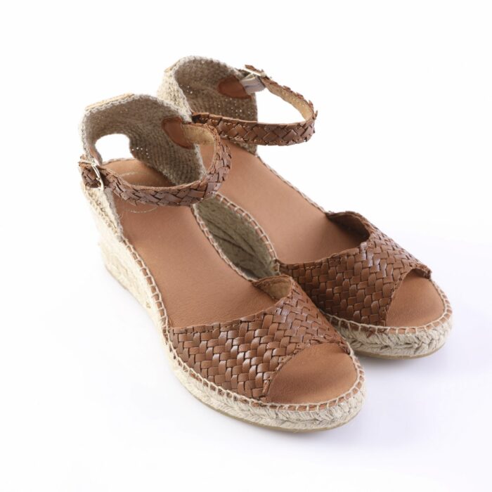 Brown braided leather sandals with ankle straps and a rope-wrapped espadrille sole, shown from a side angle on a white background, casual summer footwear.
